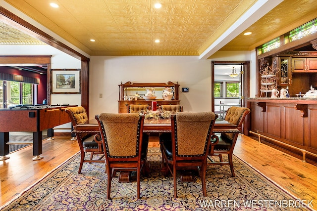 dining area featuring crown molding and light hardwood / wood-style flooring