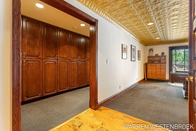 hall featuring crown molding and carpet flooring