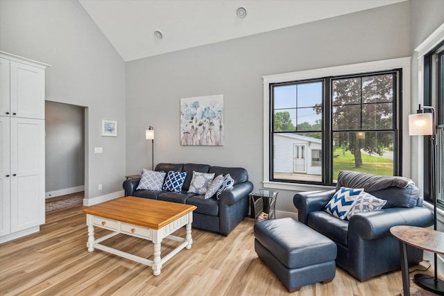 living room featuring light hardwood / wood-style flooring and high vaulted ceiling