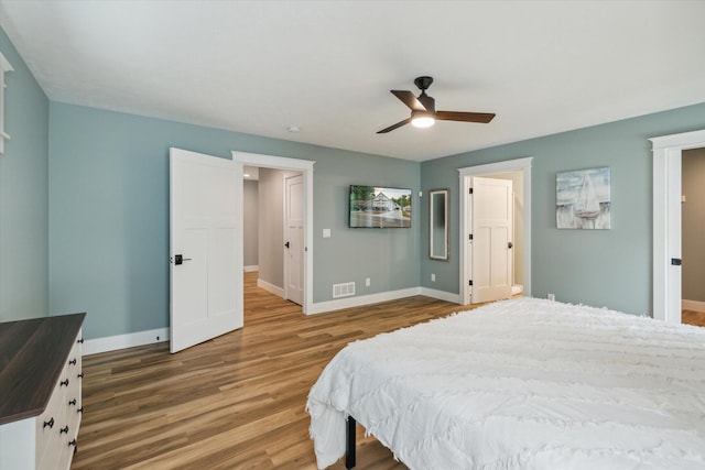 bedroom with hardwood / wood-style floors and ceiling fan