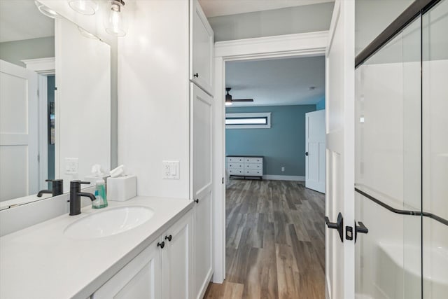 bathroom featuring wood-type flooring, vanity, and ceiling fan