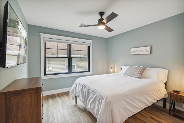 bedroom with light wood-type flooring and ceiling fan