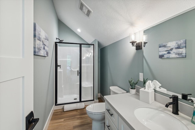 bathroom with a shower with shower door, lofted ceiling, vanity, toilet, and a textured ceiling