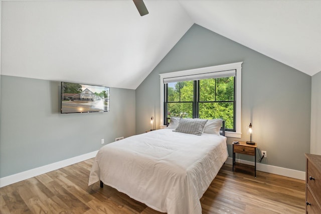 bedroom with lofted ceiling, hardwood / wood-style floors, and ceiling fan