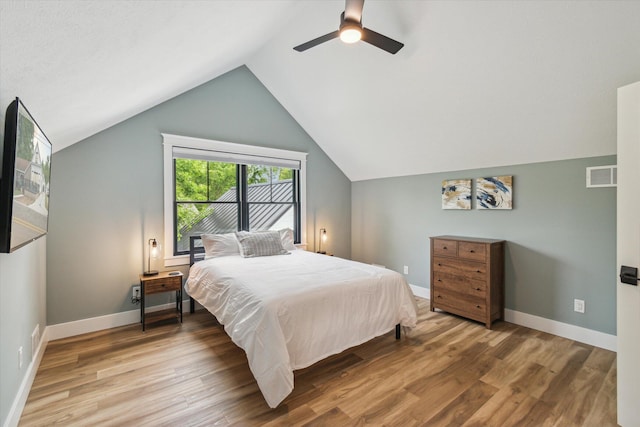 bedroom with ceiling fan, wood-type flooring, and vaulted ceiling