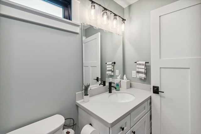 bathroom featuring vanity and toilet