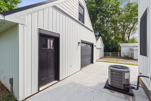 exterior space with a garage and central AC unit