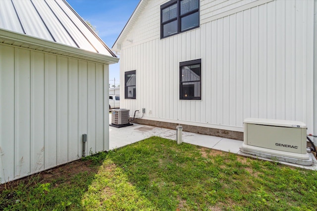 view of property exterior featuring central AC unit, a yard, and a patio