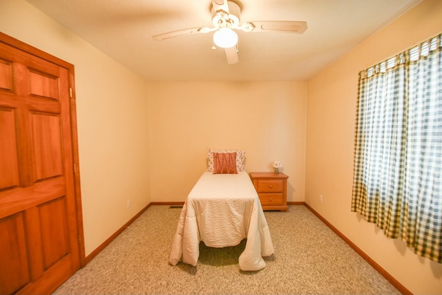 bedroom with ceiling fan and light carpet