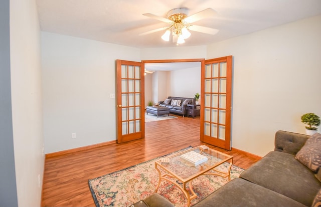 living room with ceiling fan, wood-type flooring, and french doors