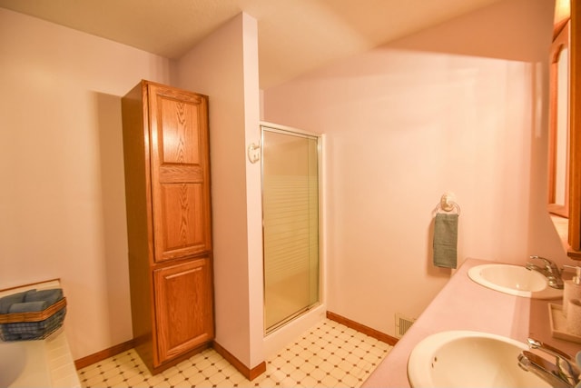 bathroom with vanity and a shower with shower door