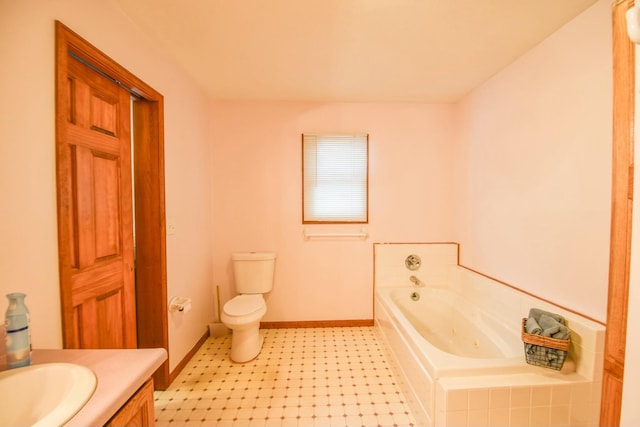 bathroom featuring a bathing tub, vanity, and toilet