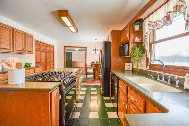 kitchen featuring hanging light fixtures, a chandelier, sink, and black appliances