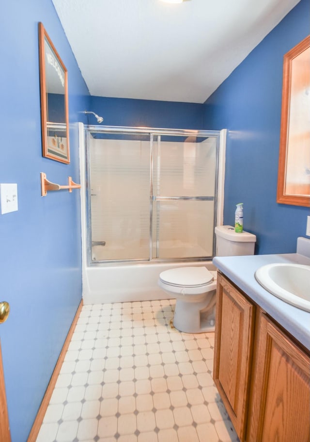 full bathroom with shower / bath combination with glass door, vanity, and toilet