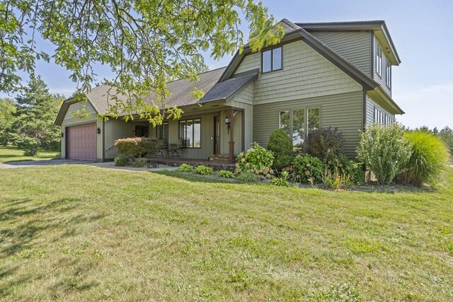 view of front of property with a garage and a front yard