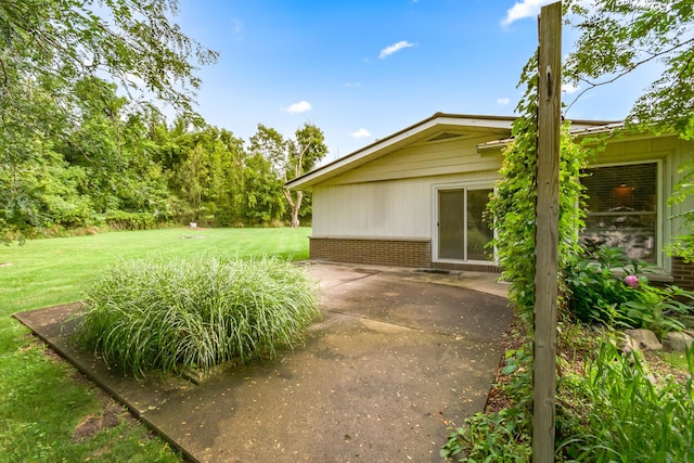 exterior space featuring a patio and a lawn