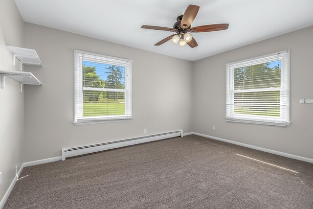 spare room featuring a baseboard heating unit, carpet floors, and ceiling fan