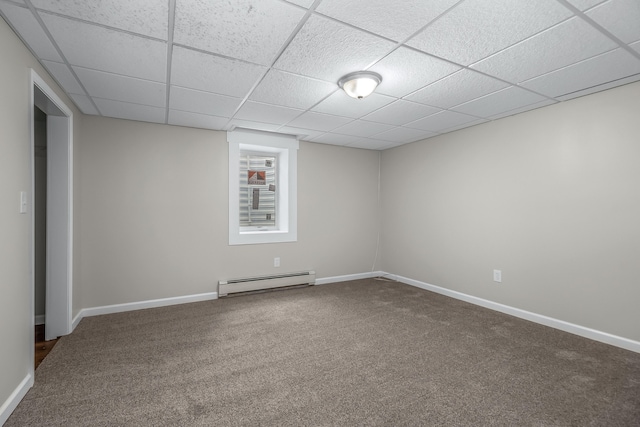 unfurnished room featuring a drop ceiling, carpet floors, and a baseboard heating unit