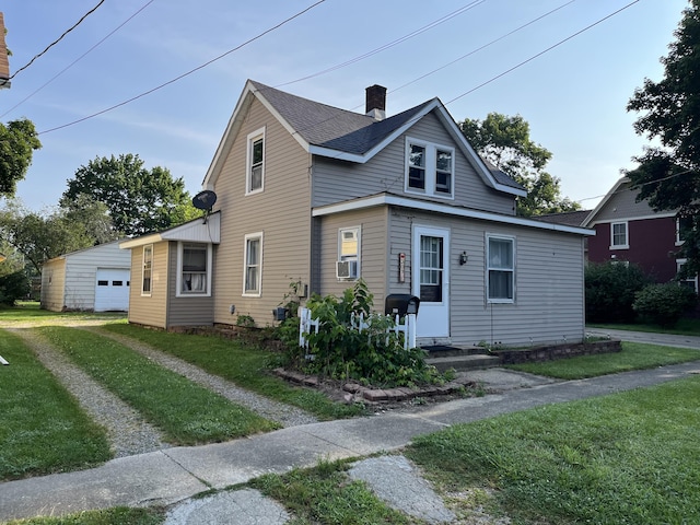 bungalow-style house with a garage, an outbuilding, a front yard, and cooling unit