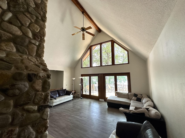 living area with wood finished floors, high vaulted ceiling, beam ceiling, ceiling fan, and a textured ceiling