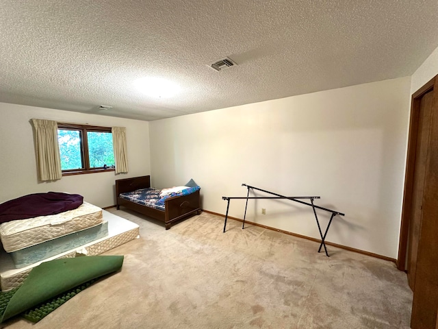 bedroom featuring a textured ceiling and carpet