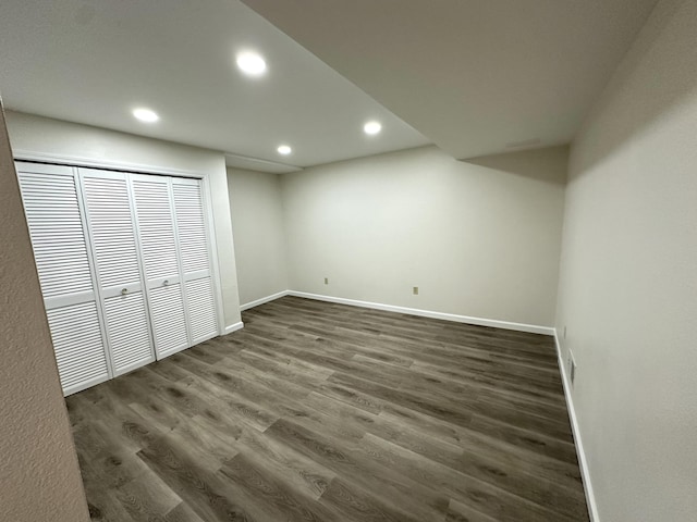 finished basement with recessed lighting, visible vents, baseboards, and dark wood-type flooring