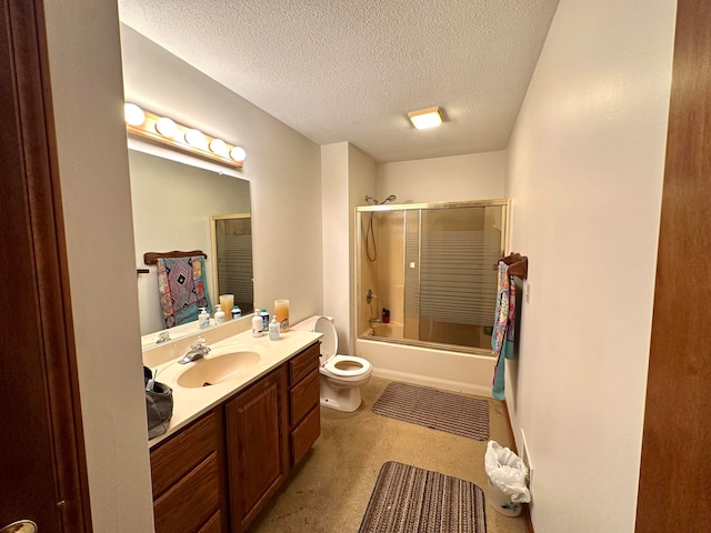 full bathroom featuring vanity, toilet, combined bath / shower with glass door, and a textured ceiling