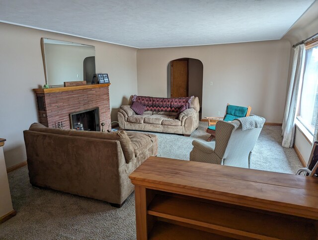 carpeted living room featuring a brick fireplace