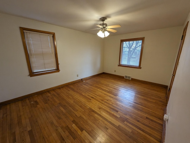 unfurnished room with ceiling fan and hardwood / wood-style floors