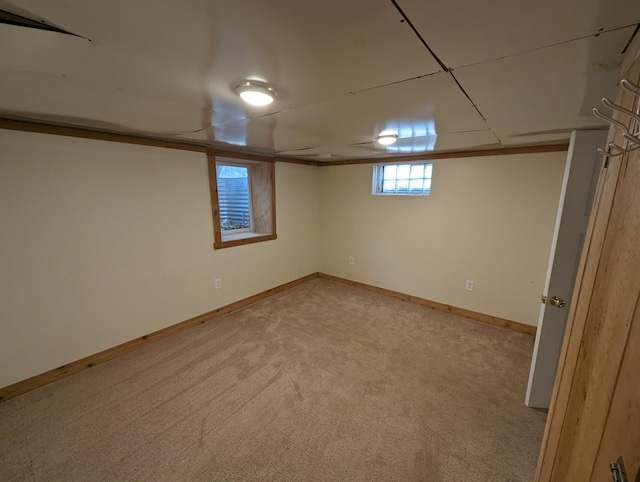 basement featuring light carpet