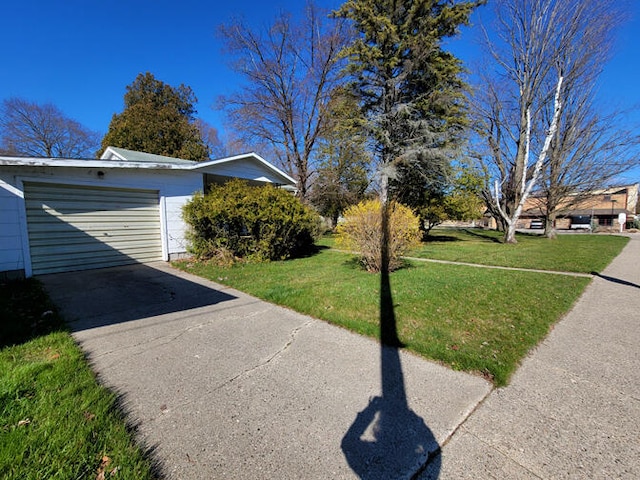 view of home's exterior featuring a lawn and a garage