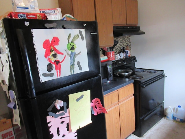 kitchen featuring black appliances and tasteful backsplash