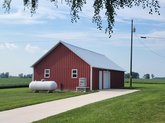 view of outbuilding with a garage and a lawn