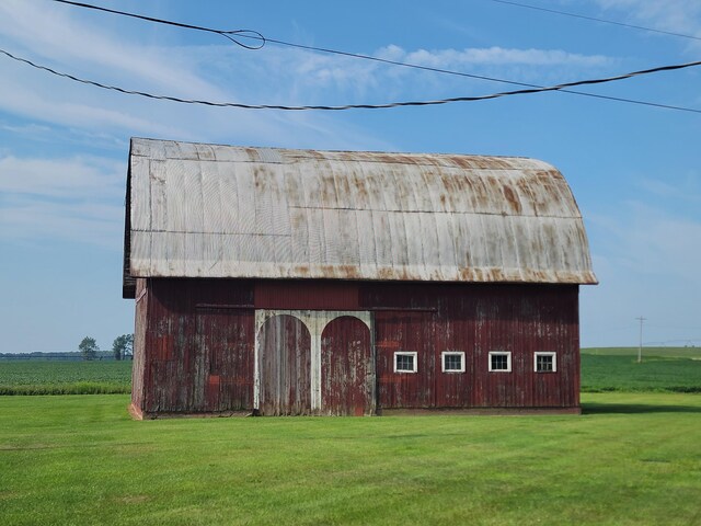 view of outdoor structure with a lawn