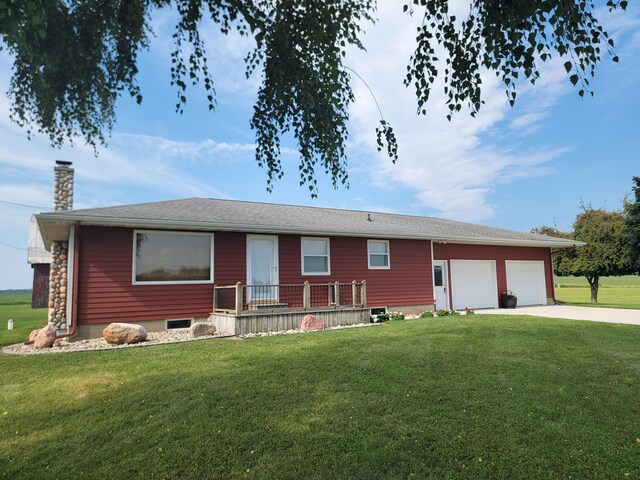 ranch-style house featuring a garage and a front yard