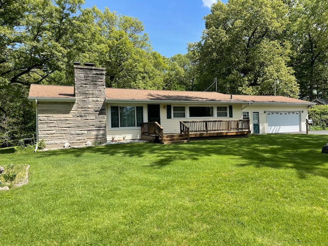 ranch-style house featuring a garage, a deck, and a front yard