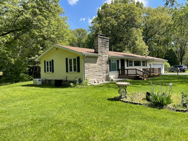 back of property with cooling unit, a deck, and a lawn