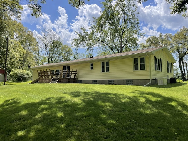 back of house with central air condition unit, a yard, and a wooden deck