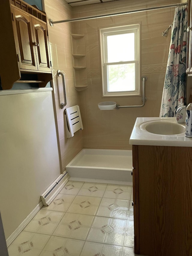 bathroom featuring shower / bath combo with shower curtain, vanity, and tile patterned flooring