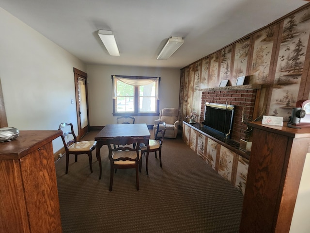 carpeted dining area featuring a brick fireplace