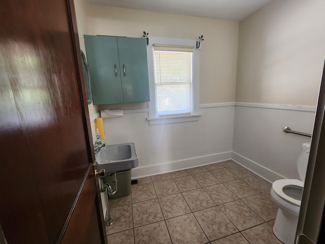 bathroom featuring tile patterned floors, toilet, and sink