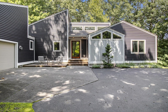 mid-century inspired home with driveway