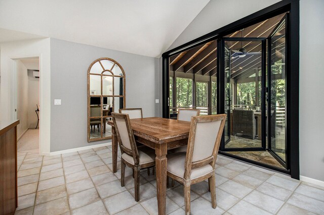 dining area with lofted ceiling and light tile patterned floors