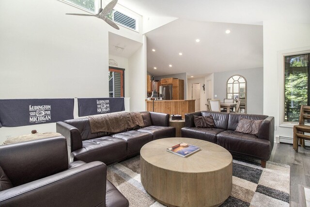 living room featuring high vaulted ceiling, ceiling fan, and hardwood / wood-style floors