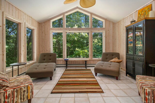 living room featuring light tile patterned flooring, wooden walls, lofted ceiling, and a baseboard heating unit