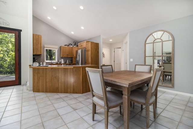 dining area with light tile patterned floors, recessed lighting, baseboards, and high vaulted ceiling