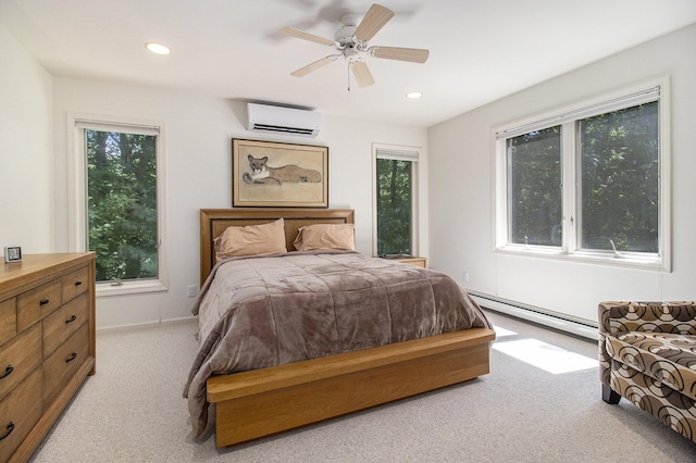 bedroom featuring a baseboard heating unit, a wall unit AC, recessed lighting, and light carpet