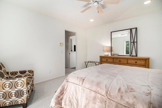 bedroom featuring light carpet and ceiling fan