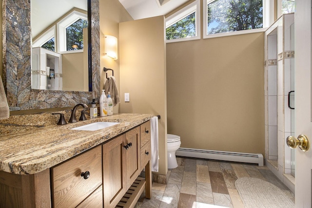 bathroom featuring a baseboard heating unit, baseboards, toilet, lofted ceiling, and vanity