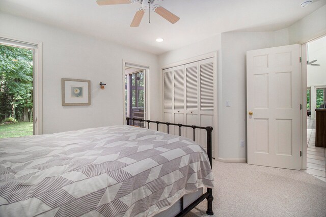 carpeted bedroom with a closet, access to exterior, and ceiling fan